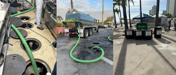 The image shows a grease trap cleaning service in progress. A large tanker truck equipped with a hose is vacuuming out the contents of a grease trap. On the right, there are several control panels that likely operate the pumping system. The setting appears to be an urban area, with palm trees and buildings in the background. This is a typical setup for maintenance and sanitation services in commercial areas where restaurants and food service establishments would require regular grease trap cleaning to ensure proper waste management and to comply with environmental regulations.